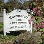 A white sign that says Ravenscroft Inn A Bed & Breakfast with their phone number.